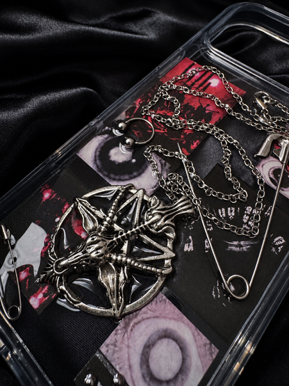 Close-up of Midnight Relic metal skeleton emblem, chains and safety pins